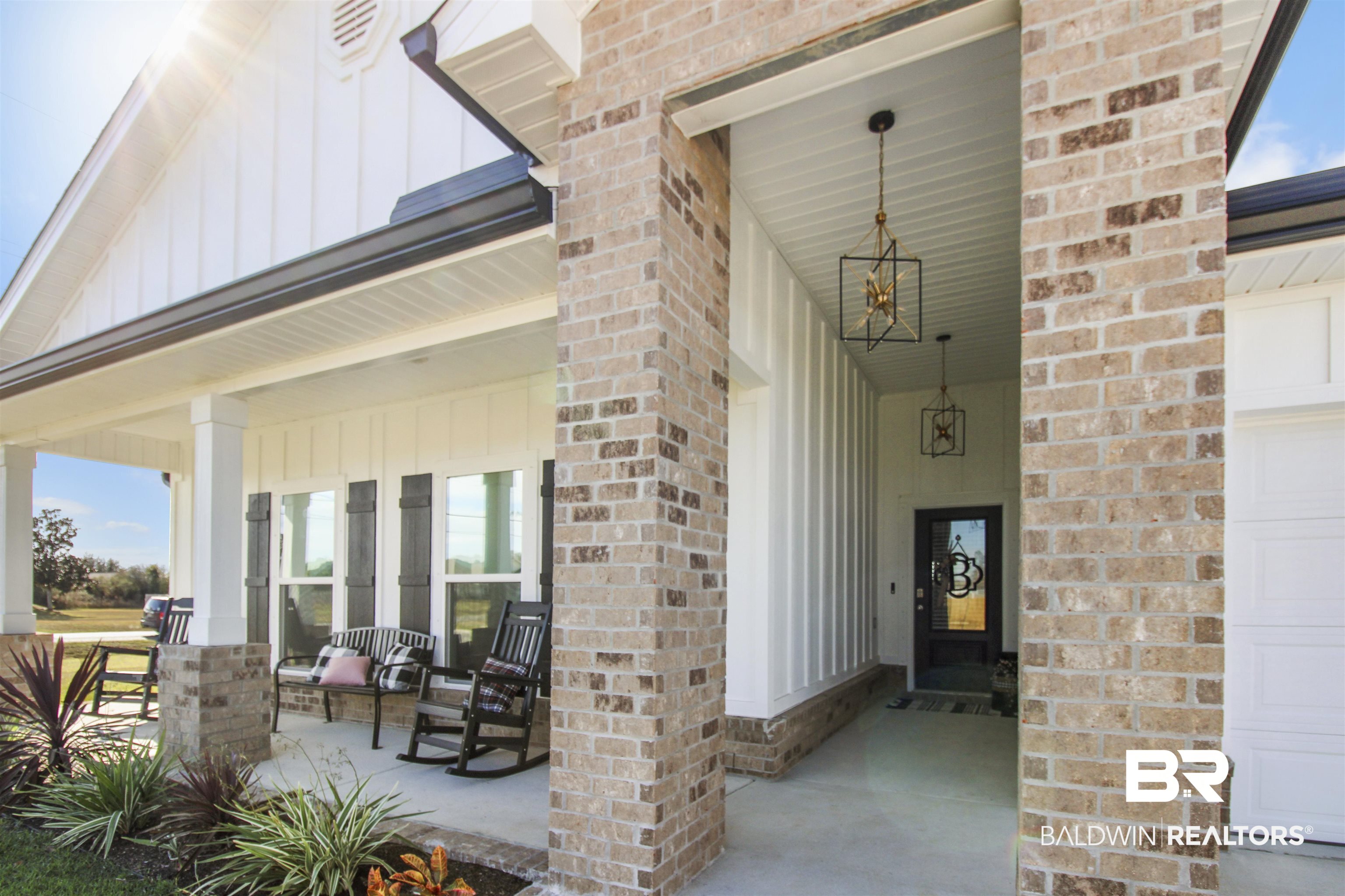 12523 Pheasant Run Elberta, AL 36530 - Photo 33 of 43 Property entrance with board and batten siding, covered porch, a garage, and brick siding