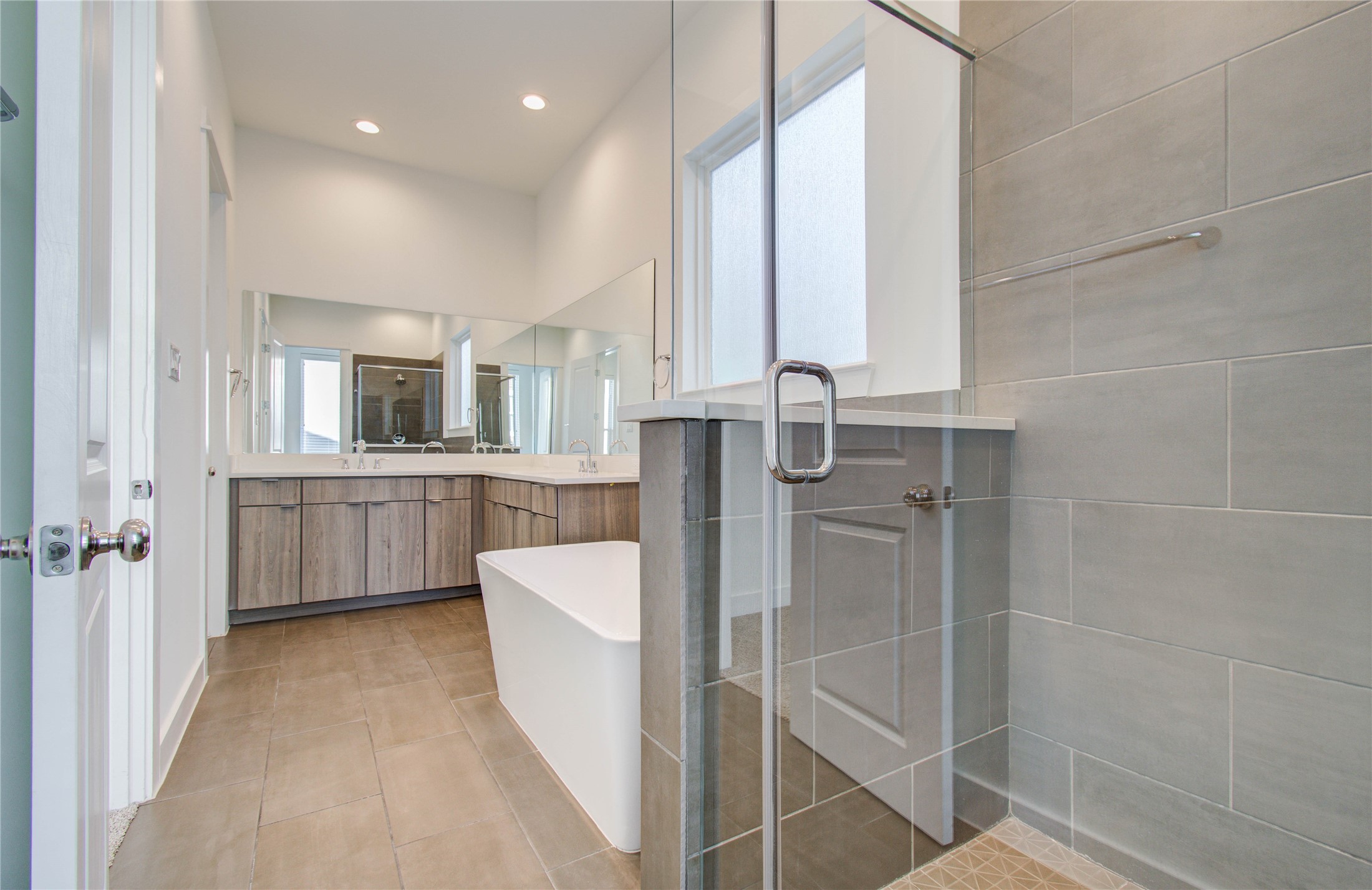 556 Janisch Road Houston, TX 77018 - Photo 26 of 29 a bathroom with a double vanity sink a mirror and a bathtub