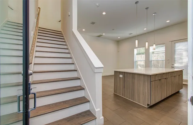 a kitchen with stainless steel appliances granite countertop a stove microwave and sink