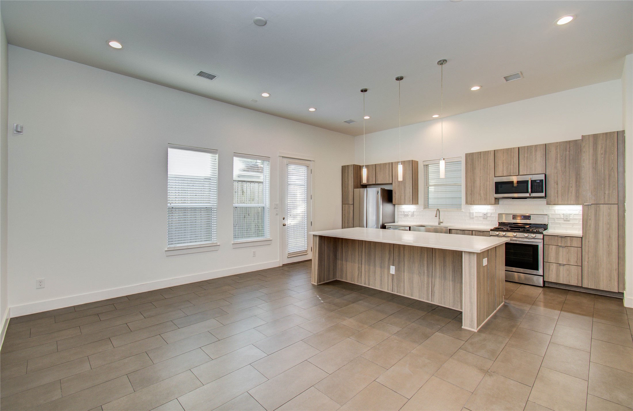 556 Janisch Road Houston, TX 77018 - Photo 6 of 29 a kitchen with stainless steel appliances a refrigerator sink and cabinets