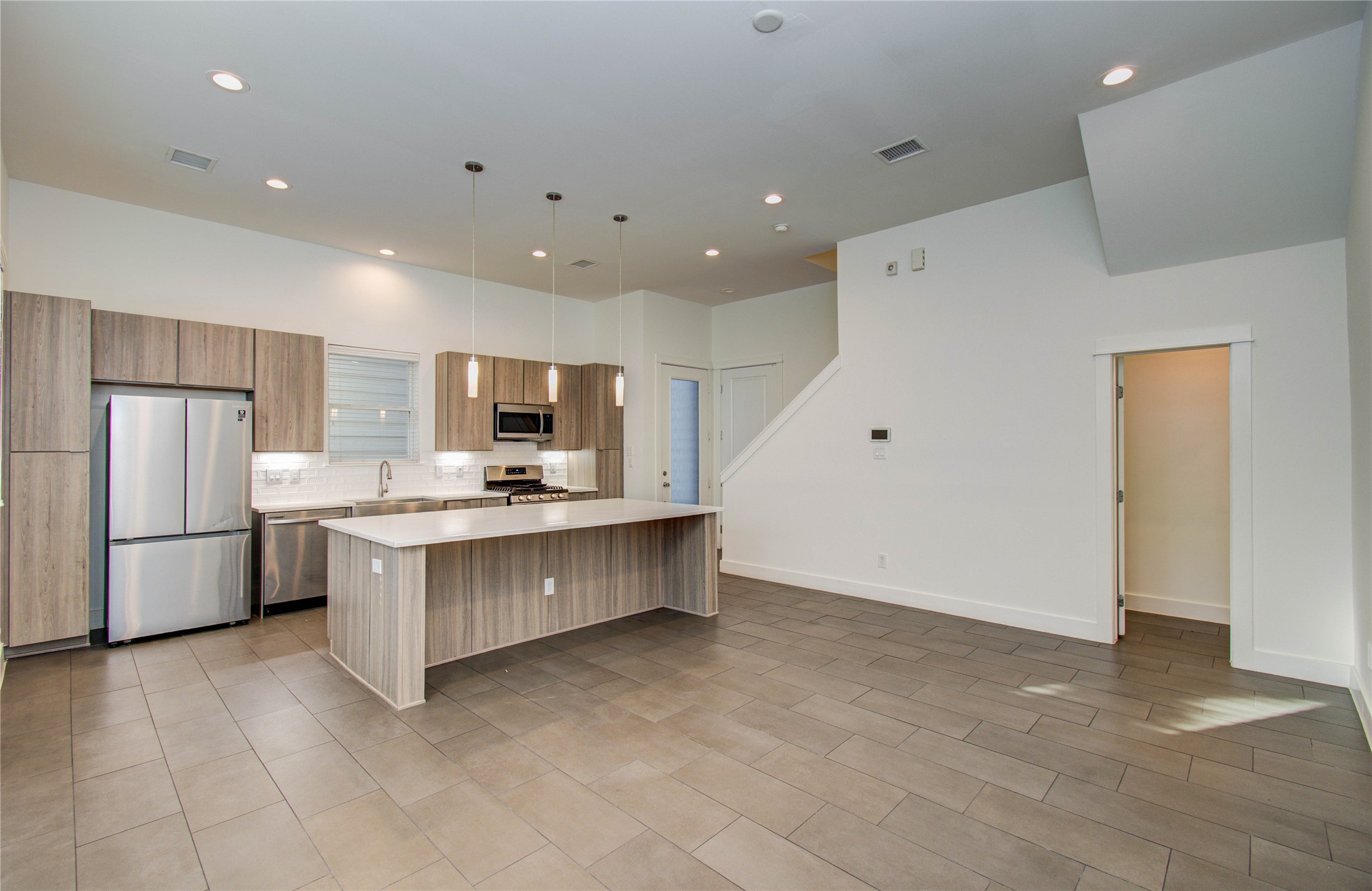 556 Janisch Road Houston, TX 77018 - Photo 7 of 29 a large kitchen with stainless steel appliances a large counter top and oven