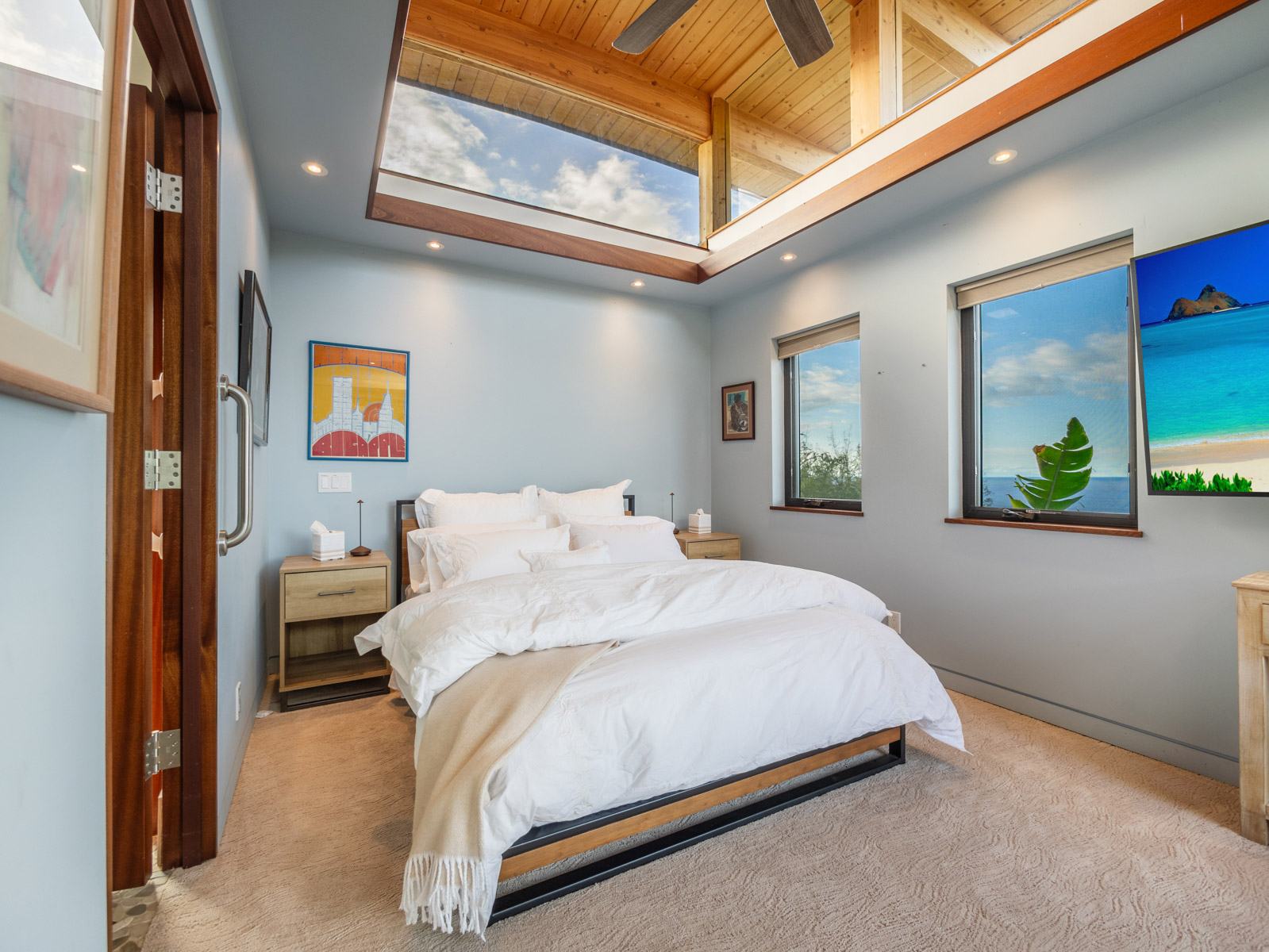 45-5038 Nānaina Kai Road Honokaa, HI 96727 - Photo 26 of 29 a bedroom with a bed and a painting on the wall