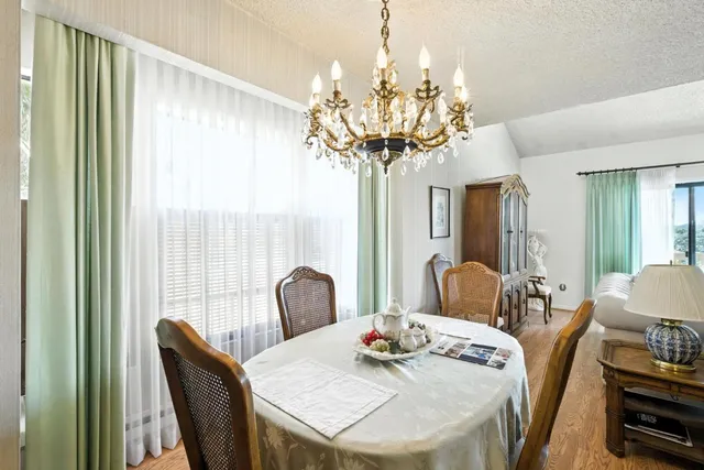 a view of a dining room with furniture wooden floor and chandelier