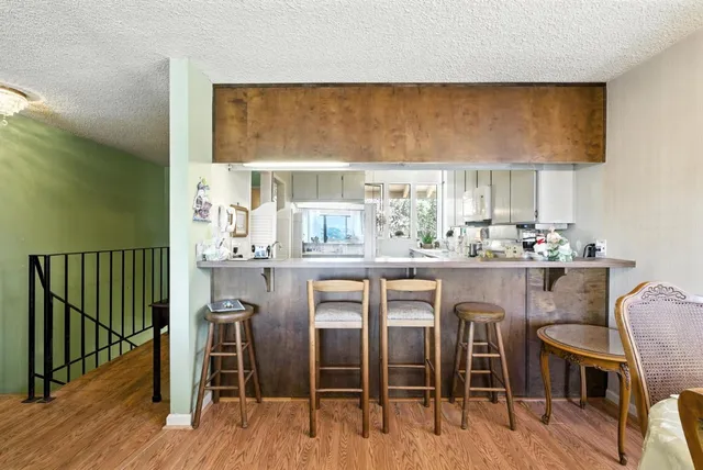 a dining table with chairs and wooden floor