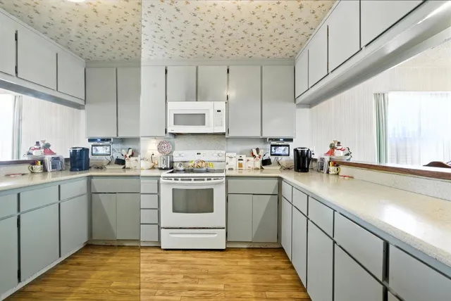 a kitchen with stainless steel appliances granite countertop a sink stove and cabinets