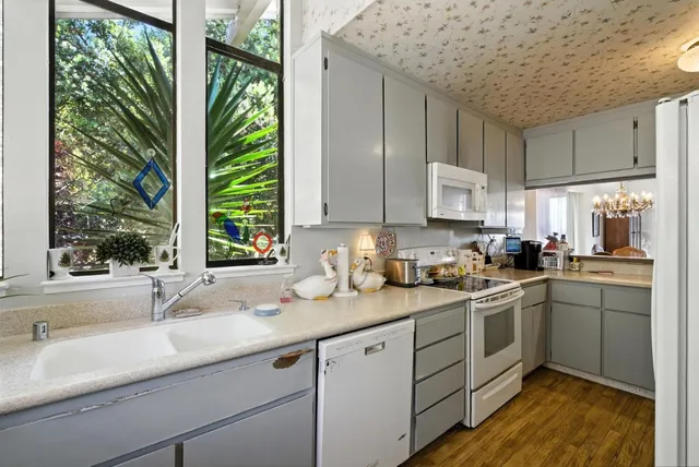 a kitchen with a sink window and cabinets