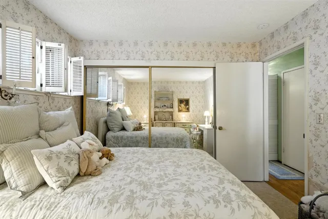 a bedroom with a bed and a large mirror
