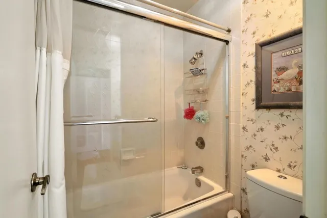 a bathroom with a shower and a toilet