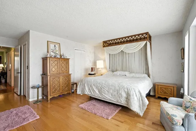 a bedroom with a bed couch and a dresser