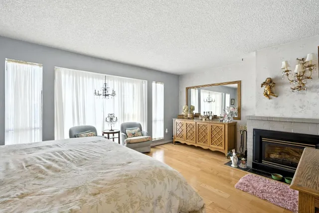 a bedroom with a bed and a fireplace