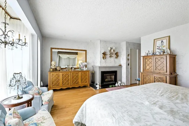 a bedroom with a bed and a chandelier