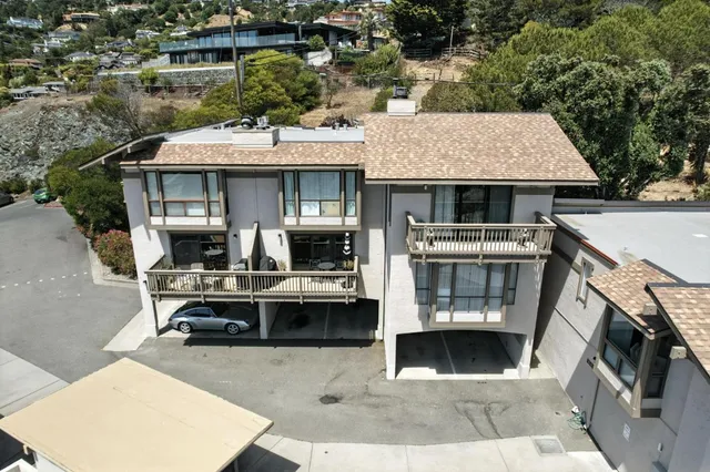 a view of a patio with table and chairs a barbeque with wooden fence