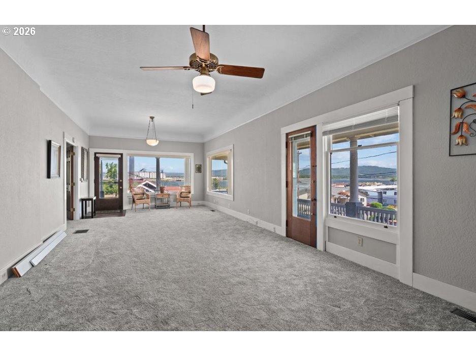 406 West C Street Rainier, OR 97048 - Photo 16 of 48 a view of a livingroom with furniture hardwood floor and a ceiling fan