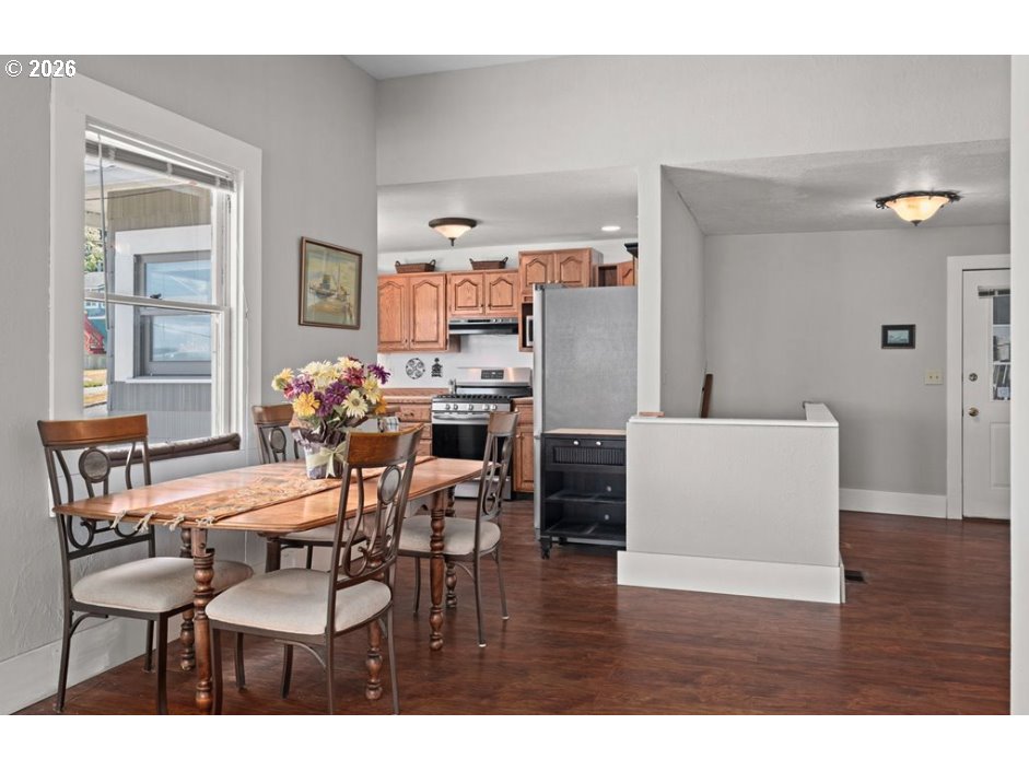 406 West C Street Rainier, OR 97048 - Photo 18 of 48 a view of a dining room with furniture and wooden floor