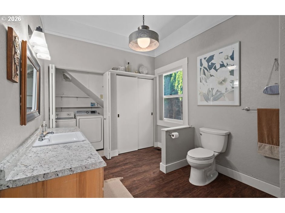 406 West C Street Rainier, OR 97048 - Photo 27 of 48 a bathroom with a granite countertop sink a toilet a mirror and shower