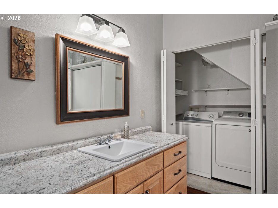 406 West C Street Rainier, OR 97048 - Photo 28 of 48 a bathroom with a sink a vanity and a mirror