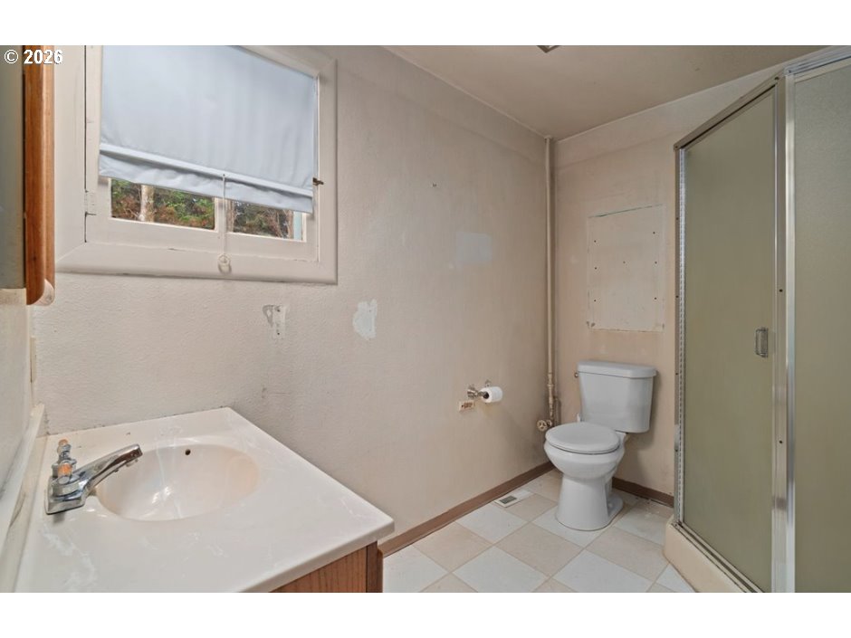 406 West C Street Rainier, OR 97048 - Photo 42 of 48 a bathroom with a sink toilet and vanity