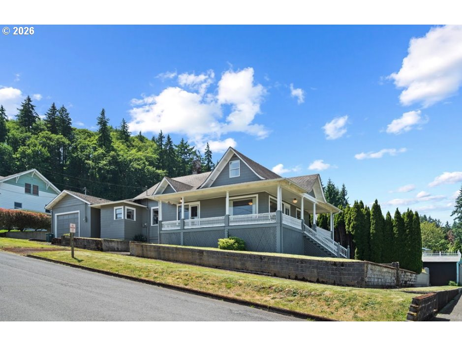 406 West C Street Rainier, OR 97048 - Photo 5 of 48 a front view of a house with a yard