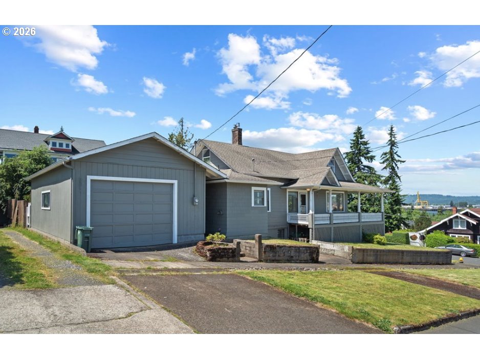 406 West C Street Rainier, OR 97048 - Photo 9 of 48 a front view of a house with a yard