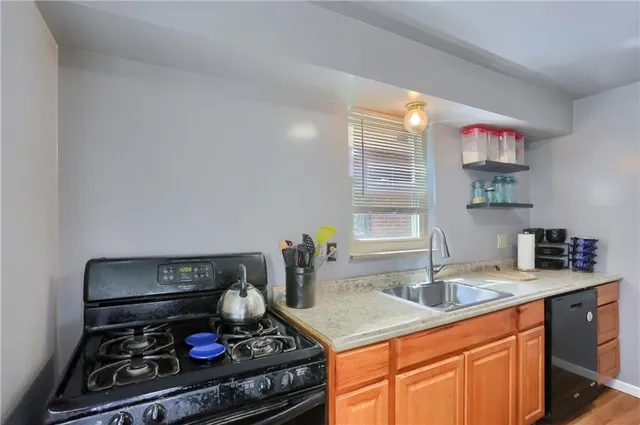 a kitchen with a stove and a sink