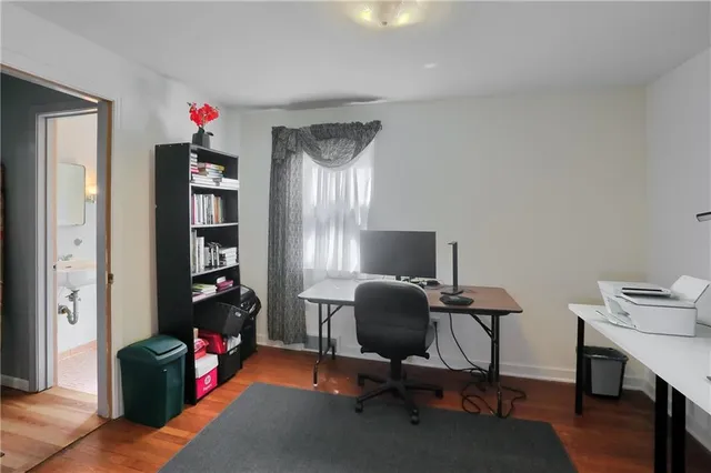 a view of a workspace with furniture and a window
