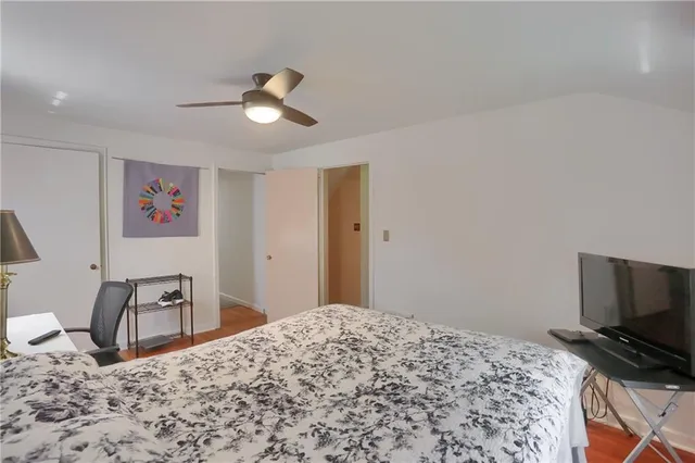 a bedroom with a bed and a flat screen tv