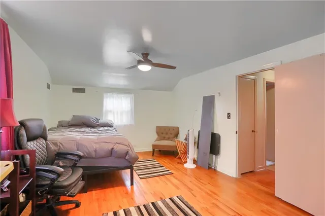 a bedroom with furniture and a wooden floor