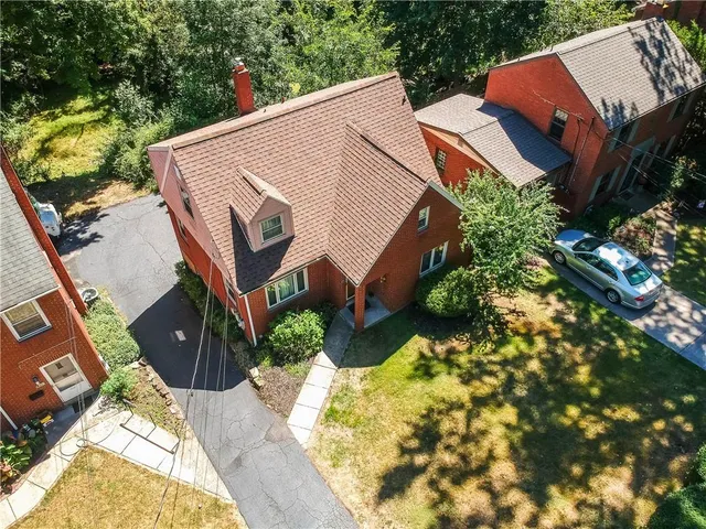 a aerial view of a house with a yard