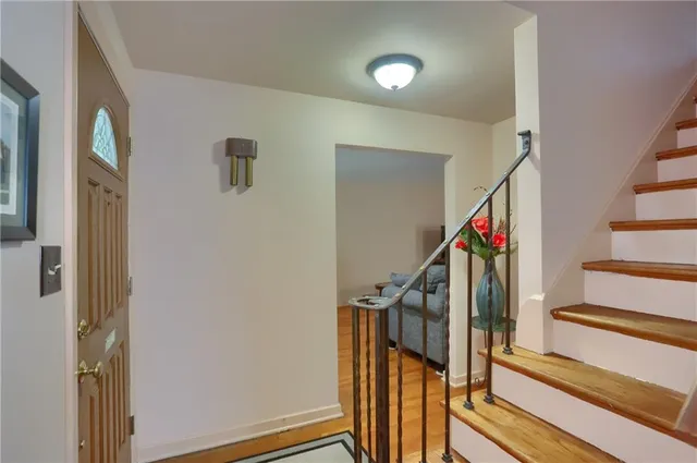 a view of an entryway with wooden floor and stairs