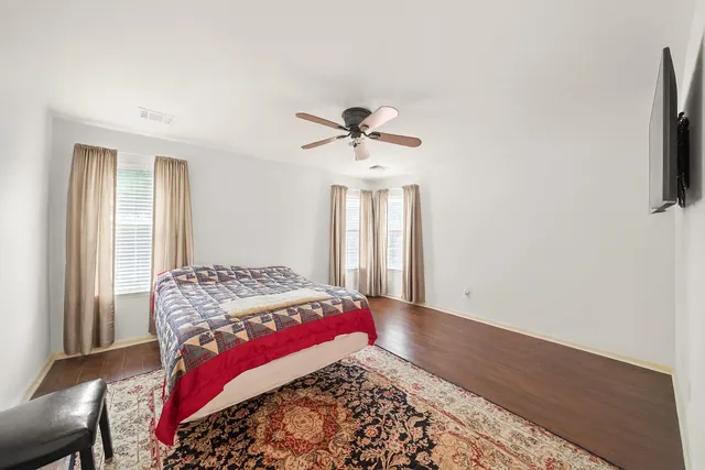 a bedroom with bed and a window