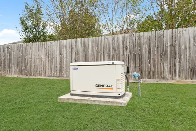 a white wooden fence in the grass