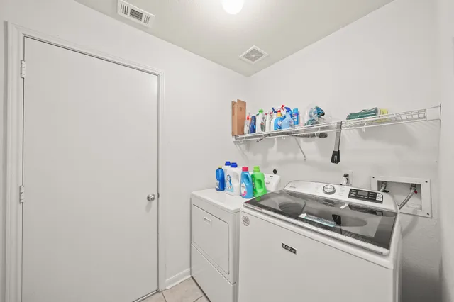 a kitchen with refrigerator and cabinets