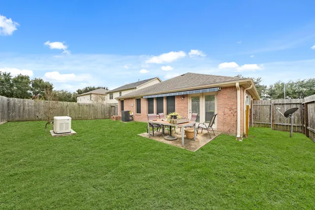 a view of a house with backyard porch and sitting area