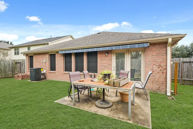 a view of a house with backyard sitting area and garden