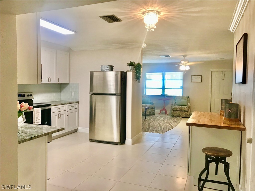 14640 Cemetery Road Fort Myers, FL 33905 - Photo 9 of 23 a kitchen with a refrigerator and a cabinets