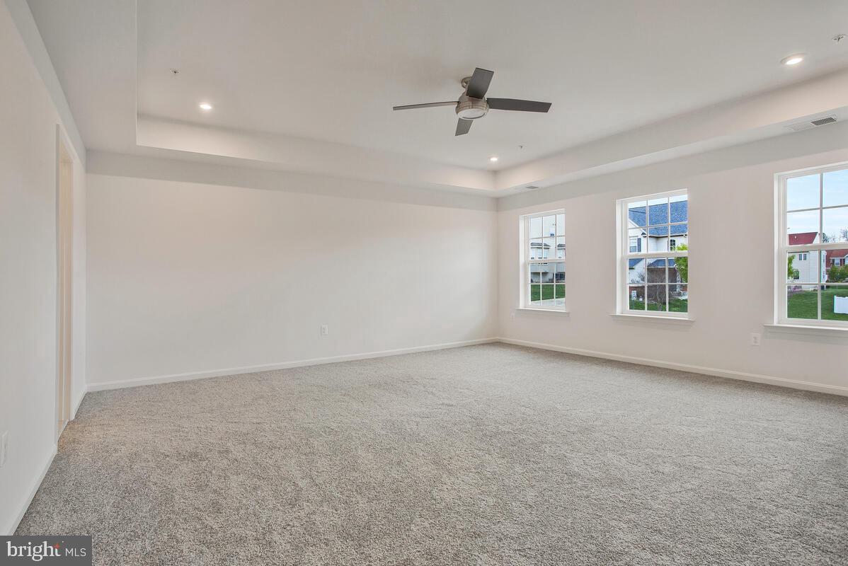 6511 Suitland Road Suitland, MD 20746 - Photo 14 of 17 an empty room with windows and ceiling fan