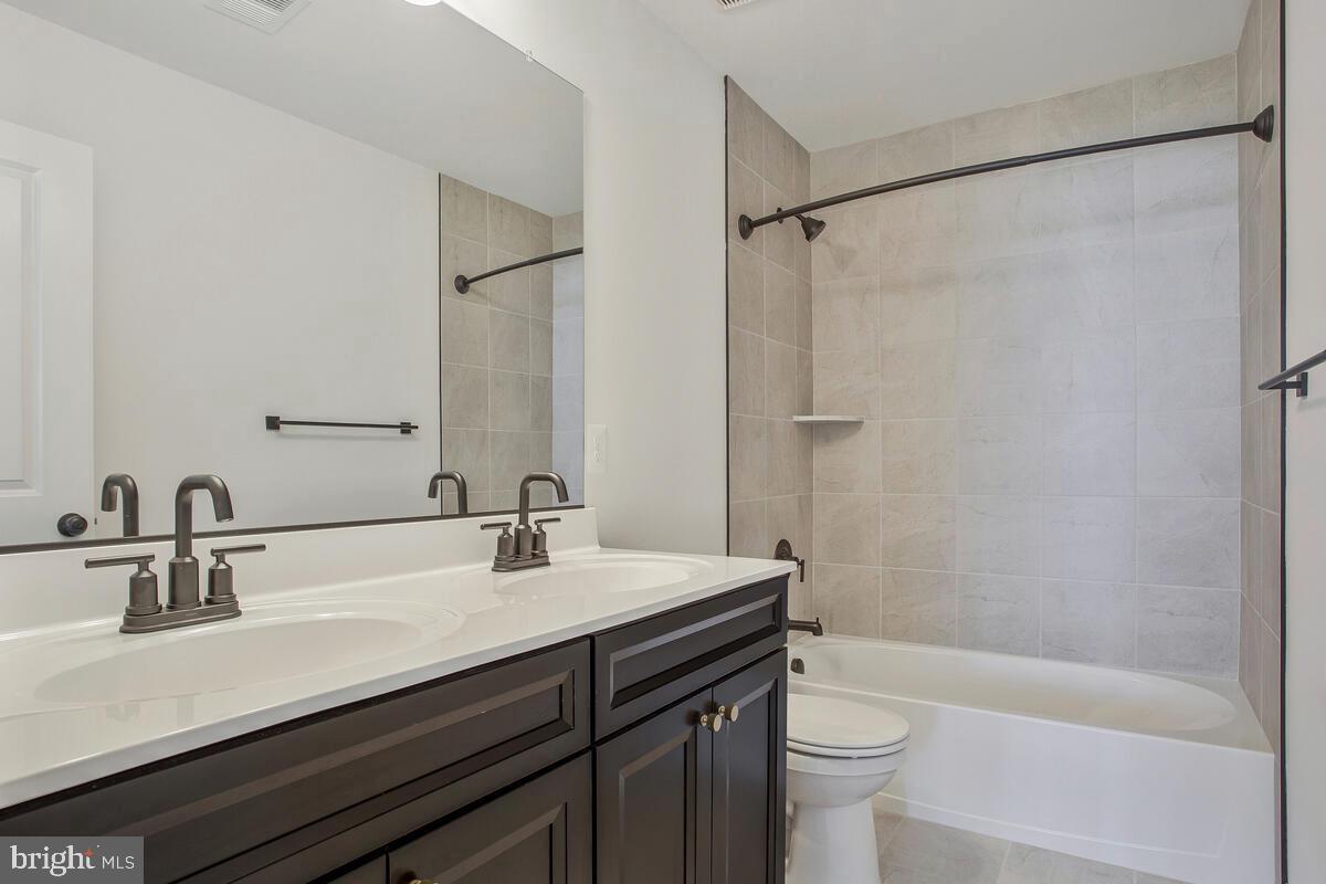 6511 Suitland Road Suitland, MD 20746 - Photo 15 of 17 a bathroom with a sink a toilet and shower