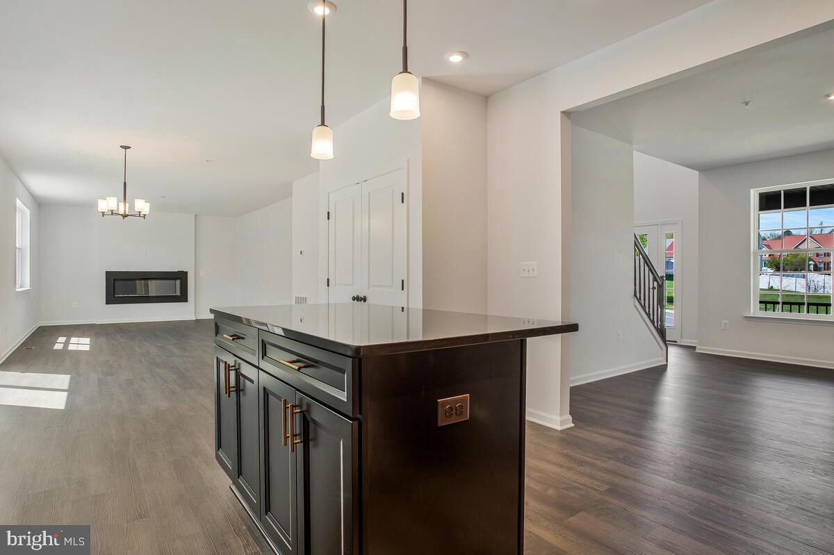 6511 Suitland Road Suitland, MD 20746 - Photo 5 of 17 a view of a kitchen with furniture and wooden floor