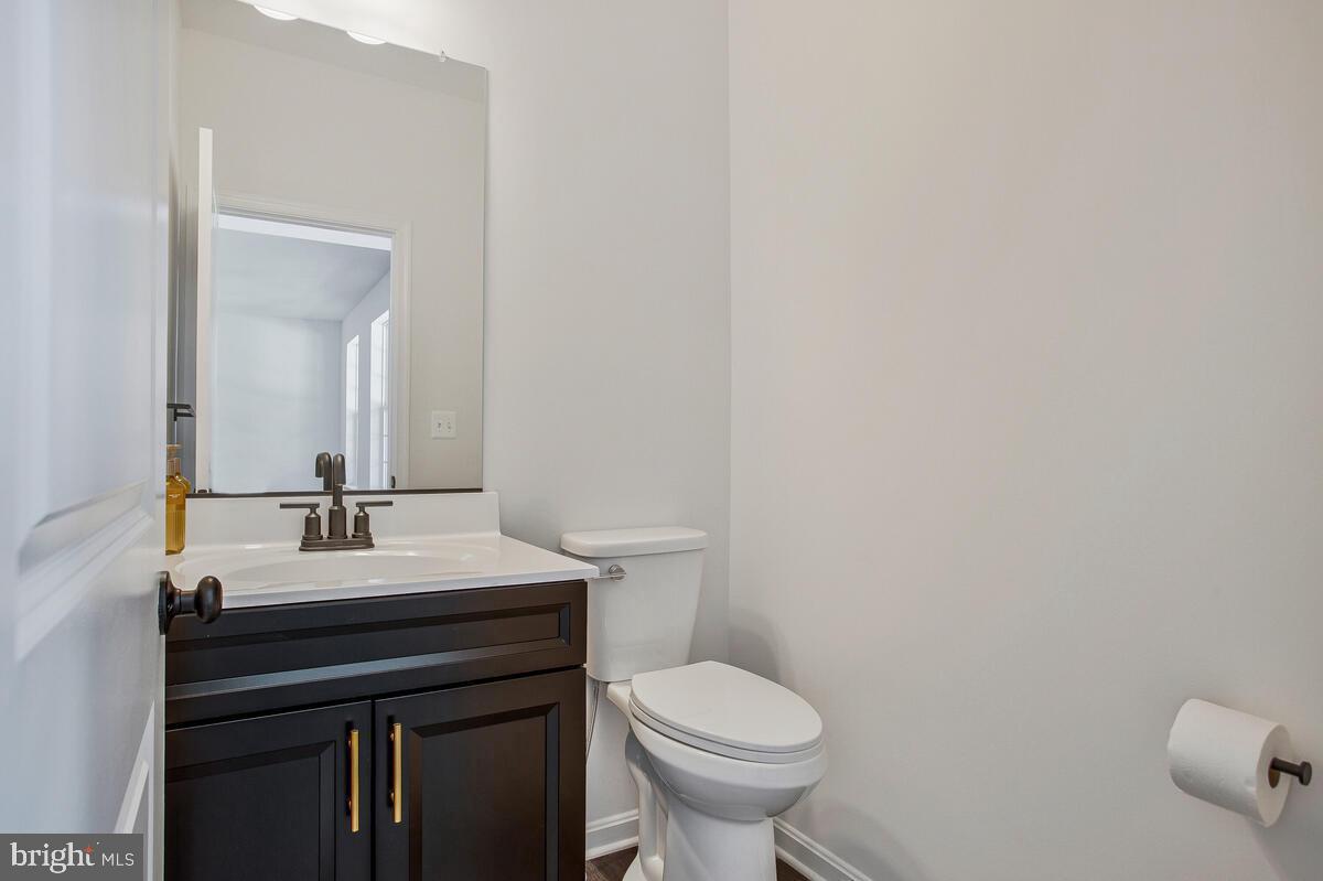 6511 Suitland Road Suitland, MD 20746 - Photo 8 of 17 a bathroom with a sink a toilet and mirror