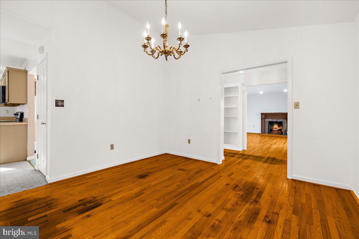 5789 Greenock Road Lothian, MD 20711 - Photo 11 of 57 a bedroom with a bed and a chandelier