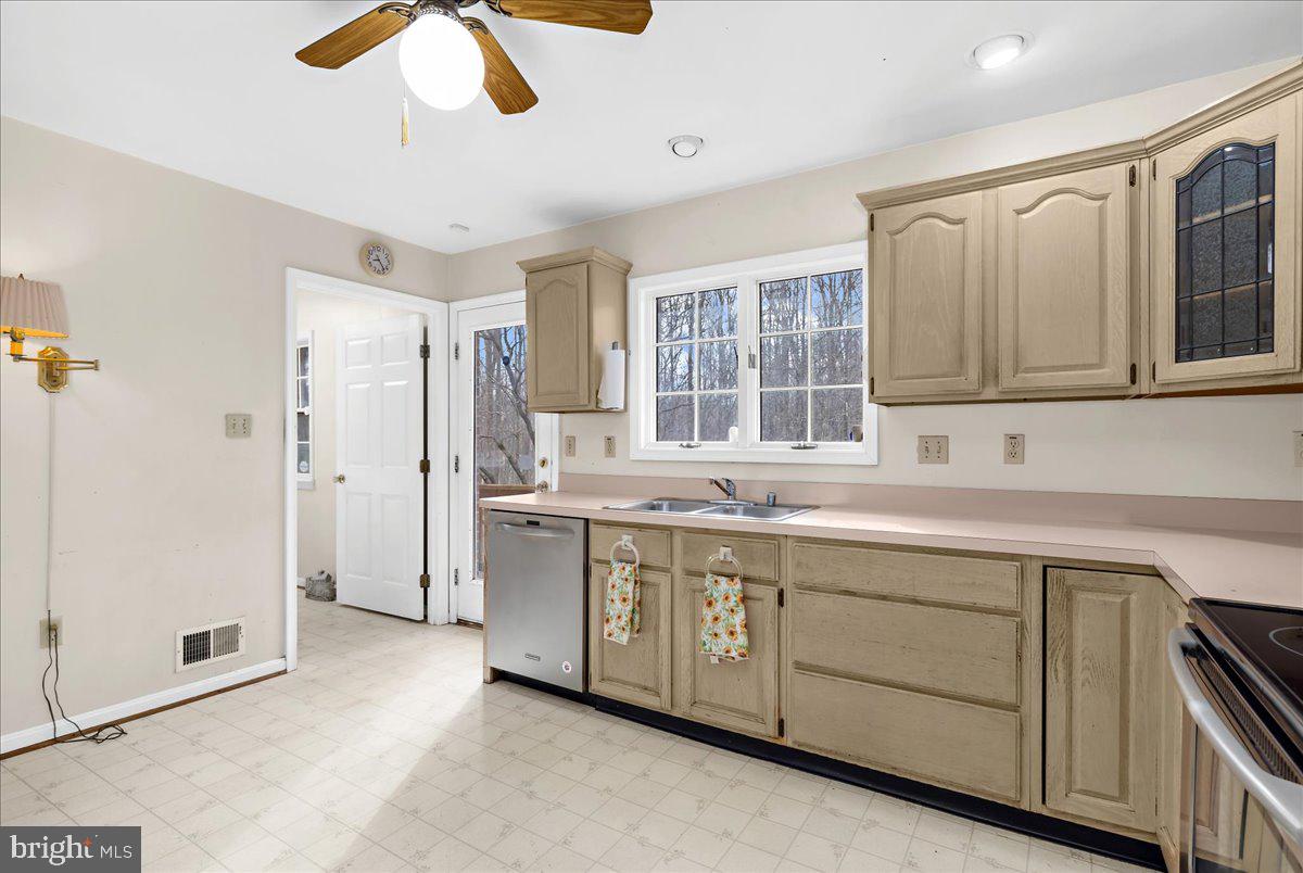 5789 Greenock Road Lothian, MD 20711 - Photo 13 of 57 a kitchen with a sink stove and cabinets