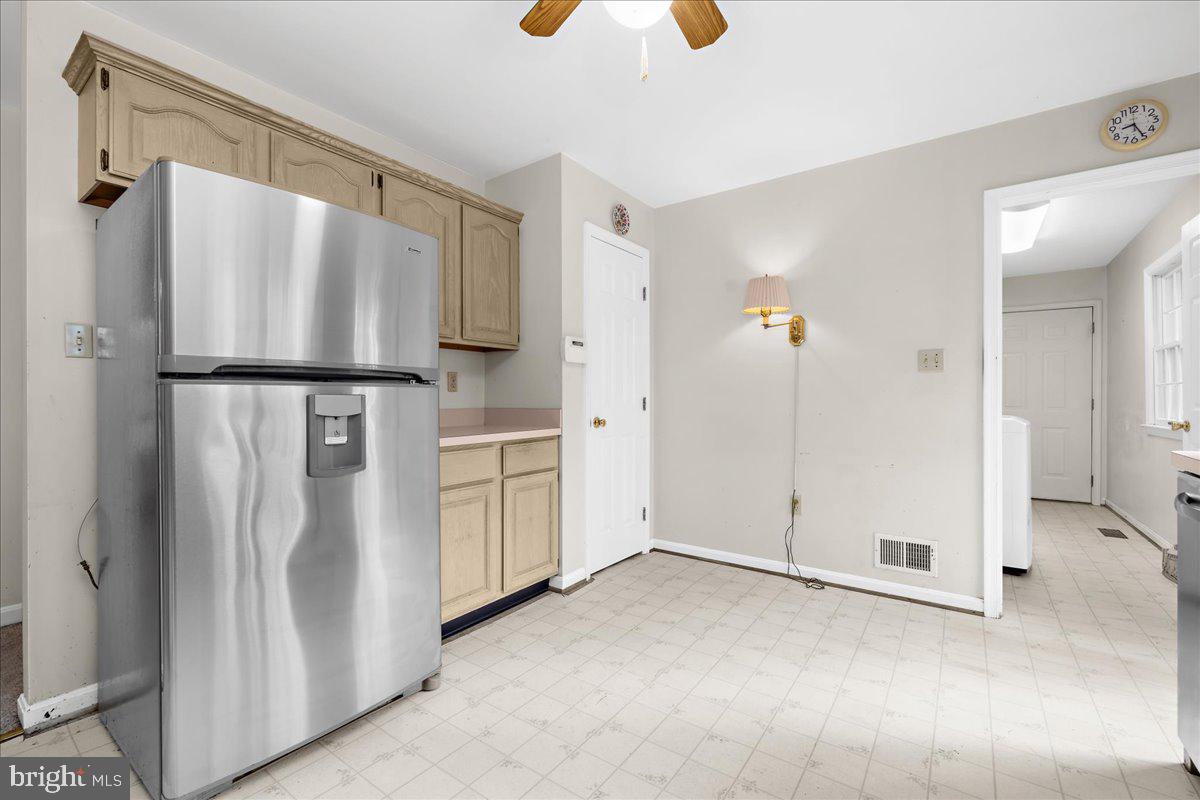 5789 Greenock Road Lothian, MD 20711 - Photo 16 of 57 a view of kitchen with refrigerator and white cabinets