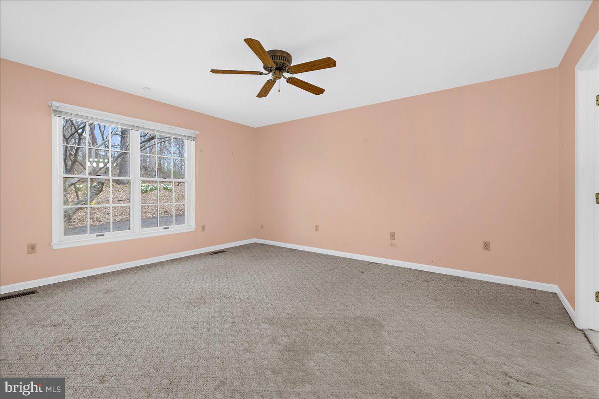 5789 Greenock Road Lothian, MD 20711 - Photo 22 of 57 a view of a big room with windows and ceiling fan