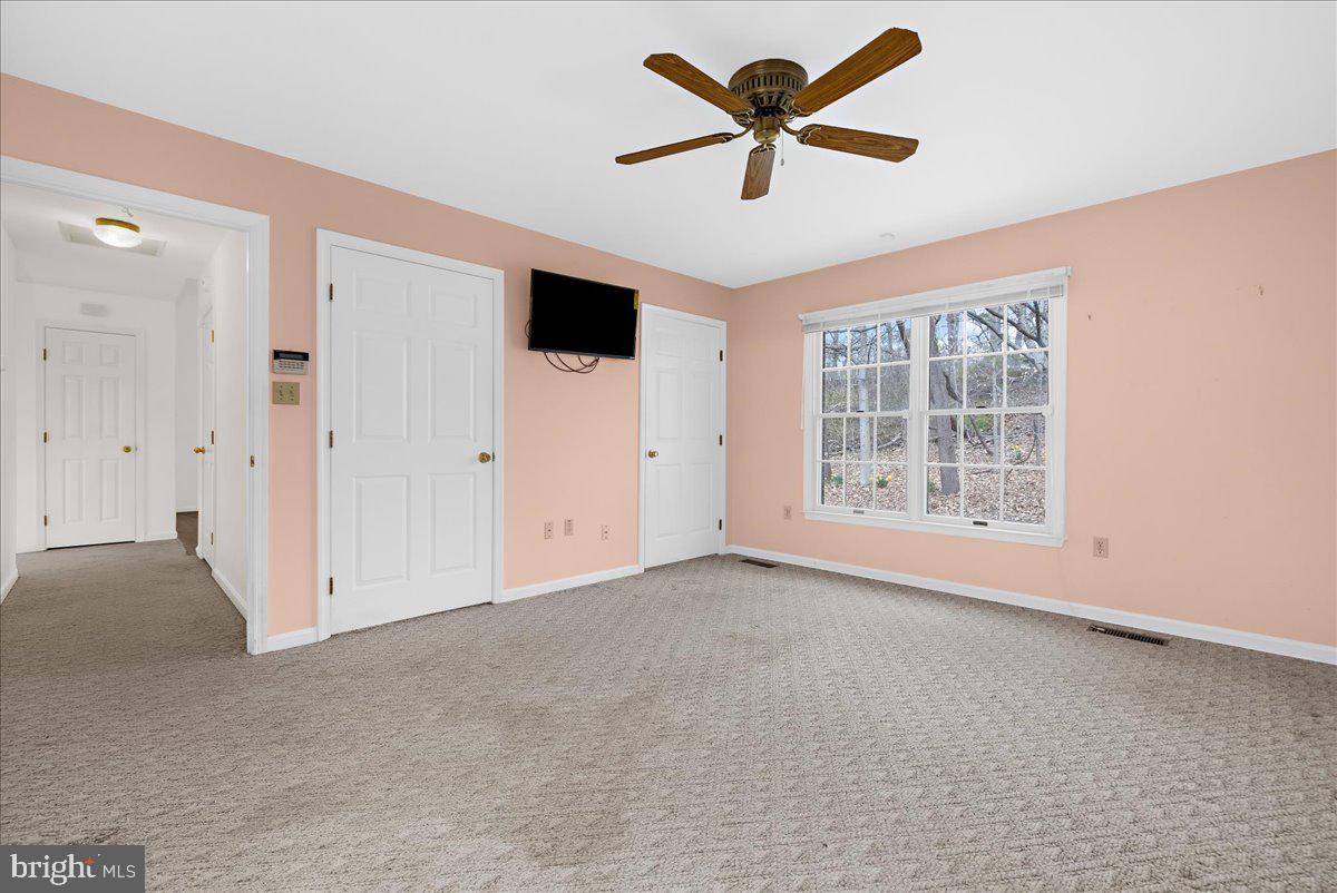 5789 Greenock Road Lothian, MD 20711 - Photo 24 of 57 an empty room with chandelier fan and windows