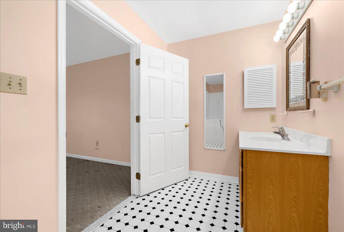 5789 Greenock Road Lothian, MD 20711 - Photo 28 of 57 a bathroom with a sink and a mirror