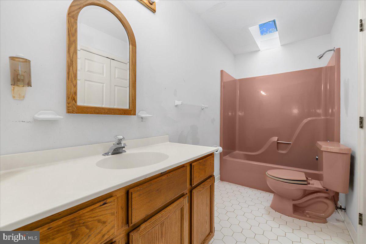 5789 Greenock Road Lothian, MD 20711 - Photo 32 of 57 a bathroom with a sink mirror toilet and bathtub