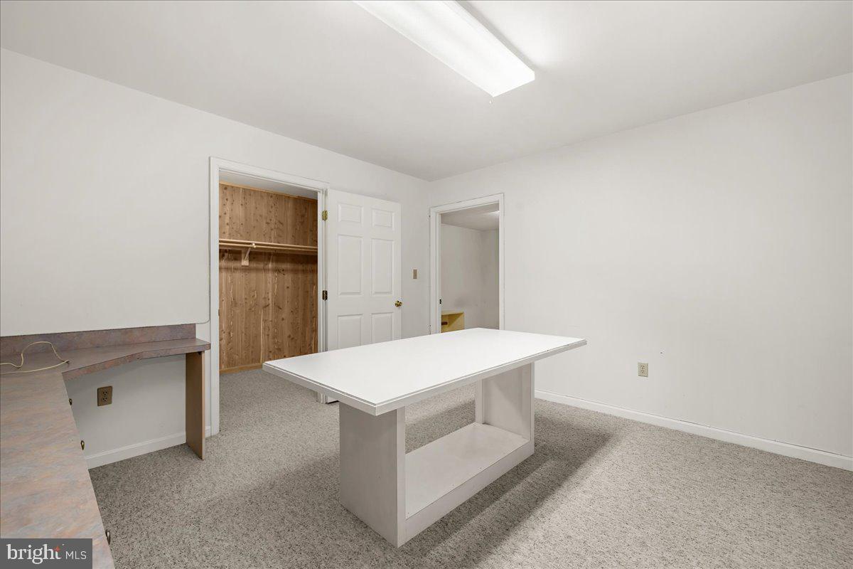 5789 Greenock Road Lothian, MD 20711 - Photo 35 of 57 a room with a table and white cabinets