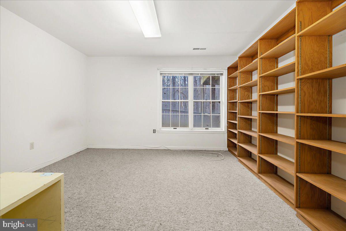 5789 Greenock Road Lothian, MD 20711 - Photo 37 of 57 a view of an empty room with empty shelves