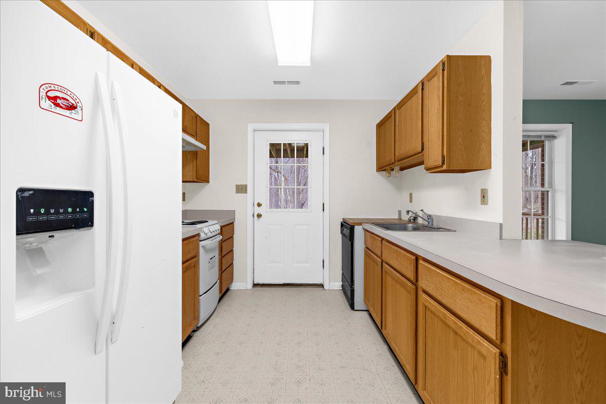 5789 Greenock Road Lothian, MD 20711 - Photo 43 of 57 a kitchen with stainless steel appliances granite countertop a sink and a stove top oven