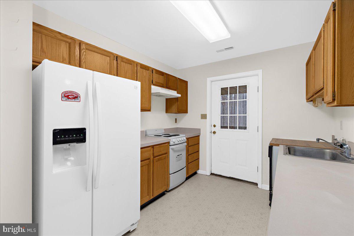 5789 Greenock Road Lothian, MD 20711 - Photo 44 of 57 a white refrigerator freezer sitting inside of a kitchen